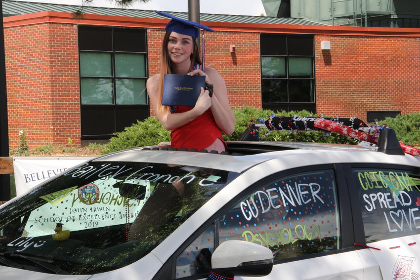 Bailey Cronch holds up her diploma cover during Cherry Creek's senior parade.